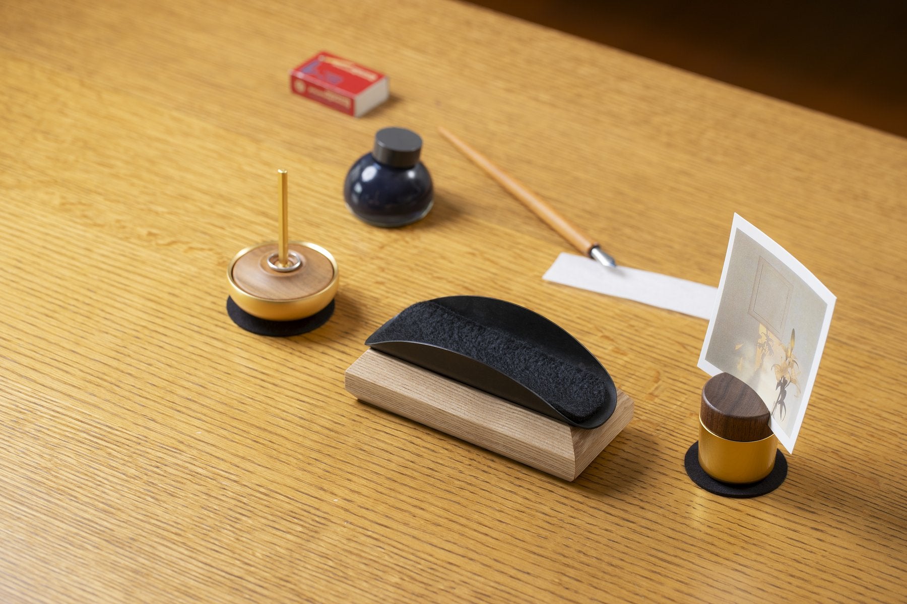 デスクに言葉を届けるセットとインク瓶、ペンを並べたシーン